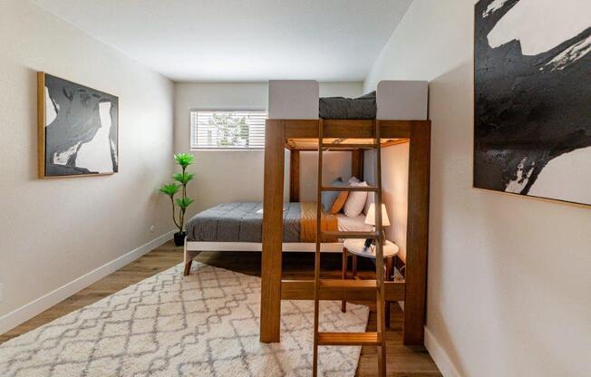 a bunk bed in a bedroom with a ladder on top