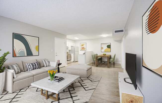 our apartments offer a living room with a couch a coffee table and a flat screen tv