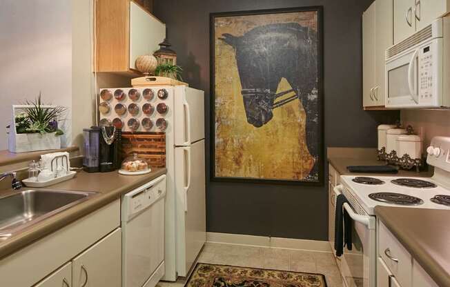 A kitchen with a painting of a horse on the wall.
