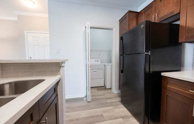 a kitchen with black appliances and a black refrigerator