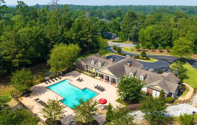 a aerial view of a house with a swimming pool and a mansion