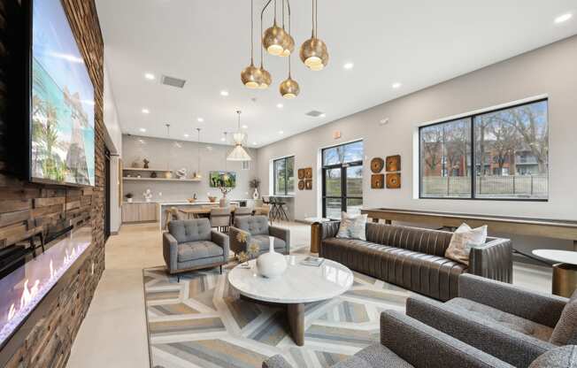 a living room with couches and chairs and a fireplace