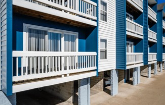 a row of blue and white rental houses