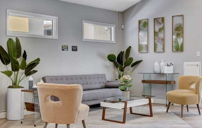 a living room with a gray couch and two yellow chairs at Summer Meadows, Las Vegas, Nevada