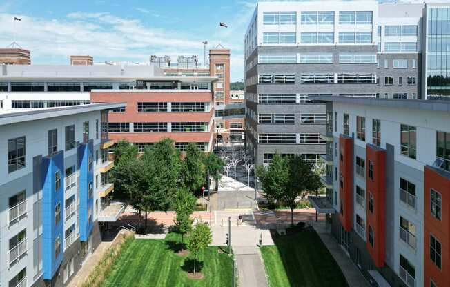 a view from the top of a building of other buildings and a grassy area