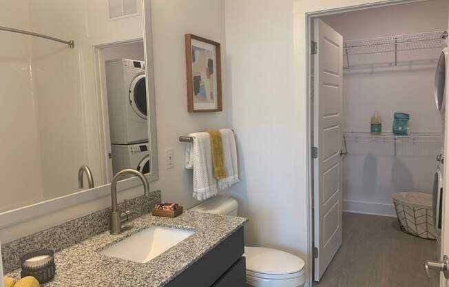 New bathroom with walk in closet and full size stack washer dryer at Link Apartments® Mixson, North Charleston, South Carolina