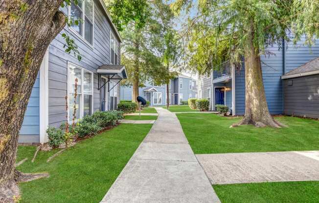 Whitney Manor Apartments in Gretna, LA photo of community buildings with greenery in between
