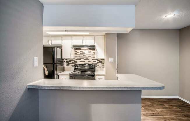 Unit Kitchen with Bar Counter at The Players Club Apartments in Nashville, TN