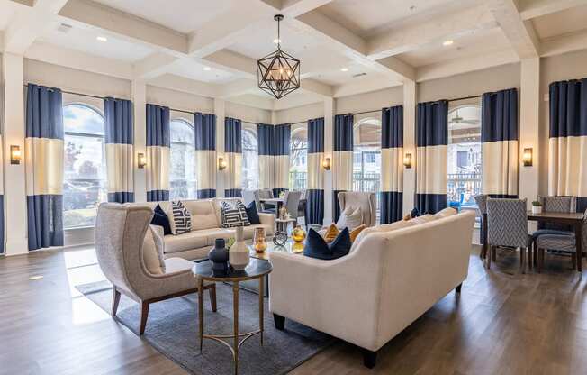 a living room with couches and chairs and a table  at Orion Prosper Lakes, Texas