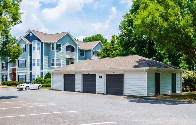 a garage with a car parked in front of an apartment building