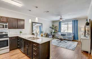 the view of a kitchen and living room with a large window