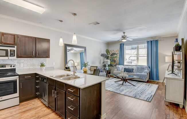 the view of a kitchen and living room with a large window