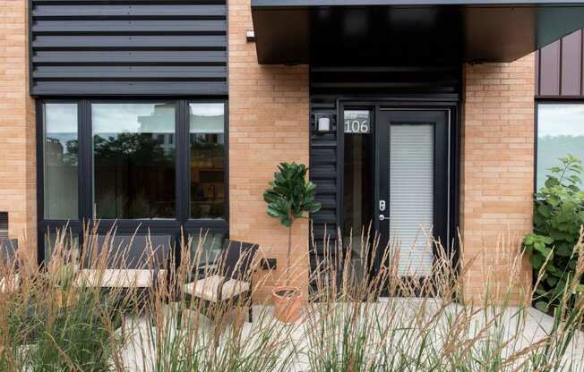 Exterior photo of Oxbo walk out terrace looking into the large exterior facing window.