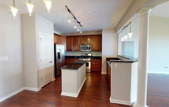 A kitchen with wooden cabinets and a black countertop.