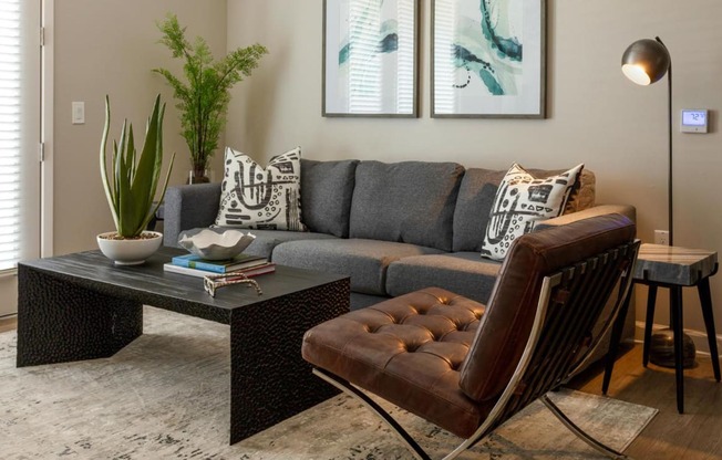 a living room with a couch and a coffee table at Esplanade District Apartments, Little Rock, Arkansas