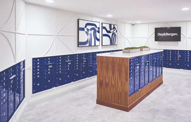 a large room with blue lockers and a wooden desk in the middle at Dey & Bergen, Harrison, 07029