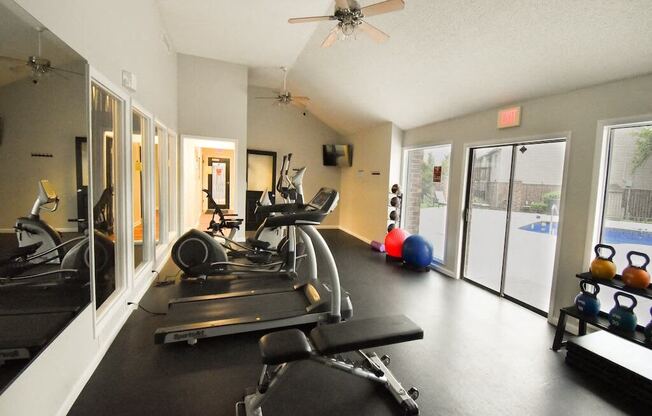 a home gym with a ceiling fan and exercise equipment