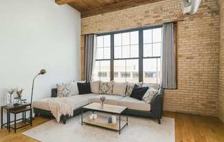 A living room with a grey couch and a coffee table.