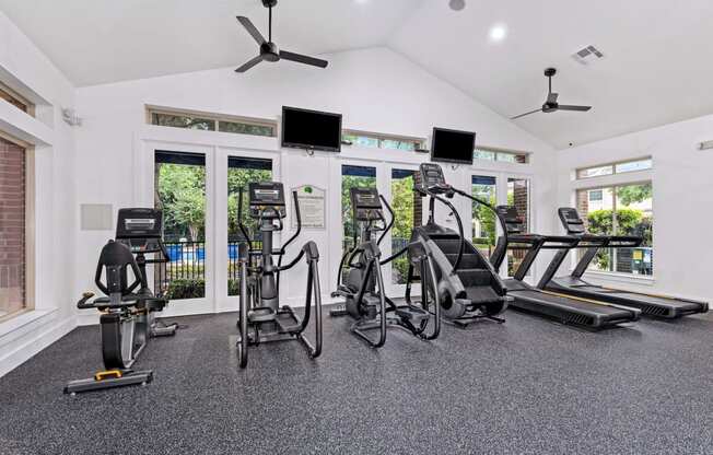 the gym has plenty of cardio equipment and windows