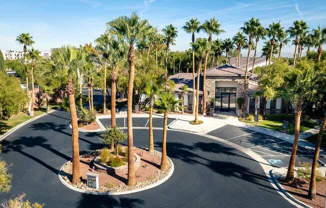 a roundabout with palm trees in front of a building