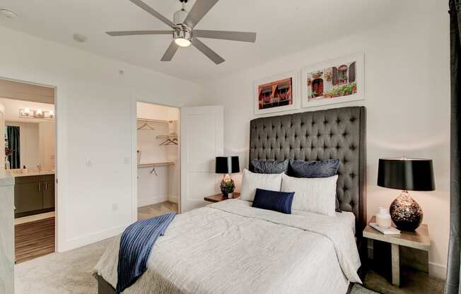a bedroom with a bed and a ceiling fan