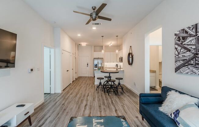 a living room with a couch and a ceiling fan