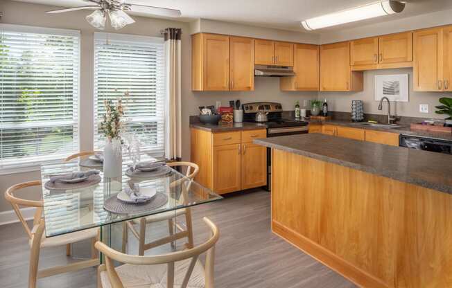 a kitchen with wooden cabinets and a table with chairs