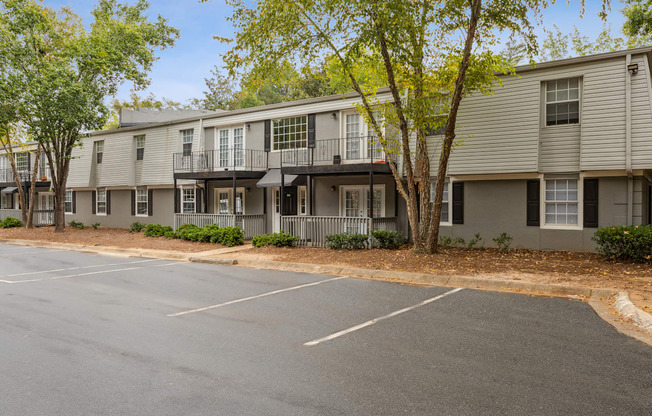 an empty parking lot in front of an apartment building