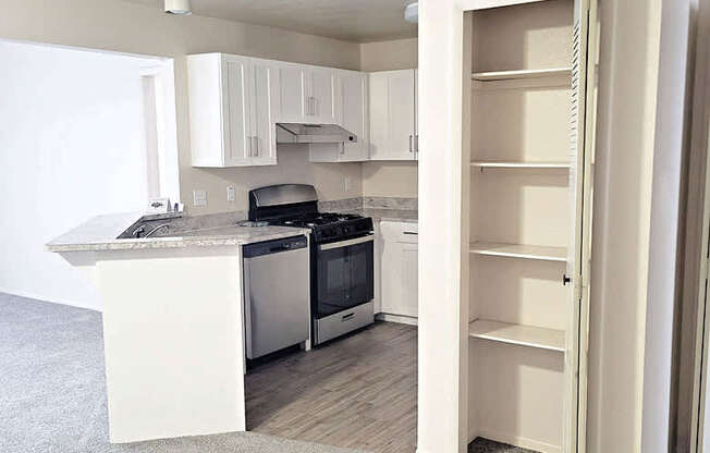 Upgraded kitchen with white cabinets at Emerald Park Apartments in Michigan 49001