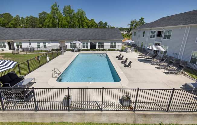 our apartments have a large pool and lounge chairs in the yard