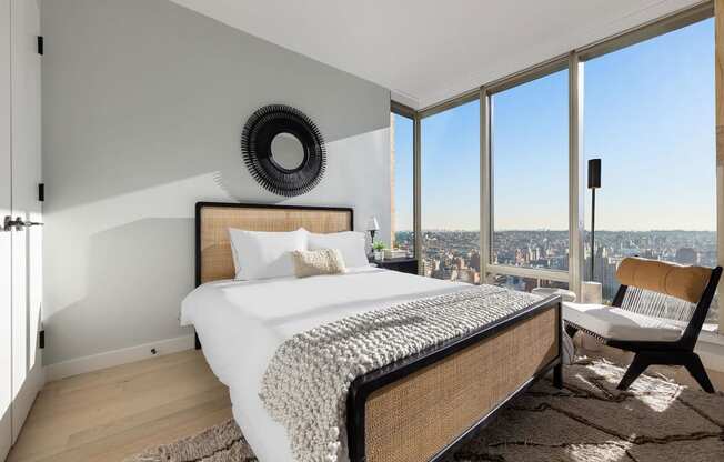 a bedroom with a bed and a view of the city at The Paxton, Brooklyn, 11201