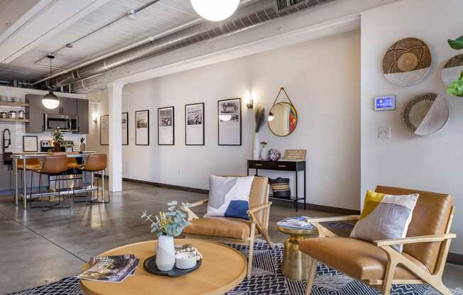 a living room with a couch and chairs and a table at Highland Mill Lofts, Charlotte, North Carolina