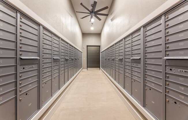 A long hallway with a row of mailboxes on either side.