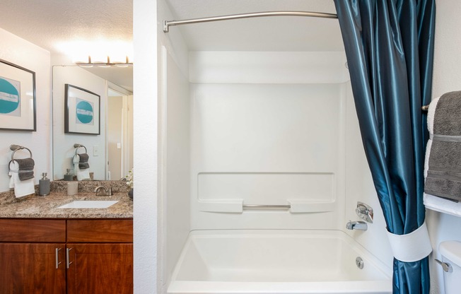 a bathroom with a shower and a sink and a bath tub