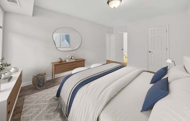 A bedroom with a large bed and a mirror on the wall.