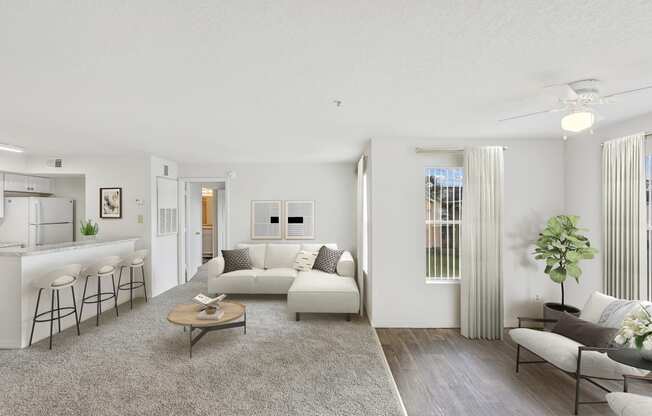 a living room with white couches and a coffee table