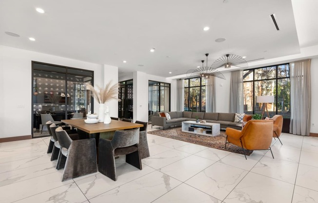 a large living room with white walls and tiles flooring at The Colony, Charlotte, NC