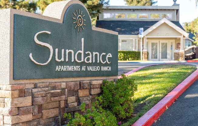 a stone monument sign for the sundance apartments at villas at valley blvd