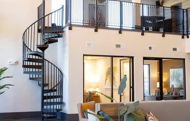 A living room with a spiral staircase.