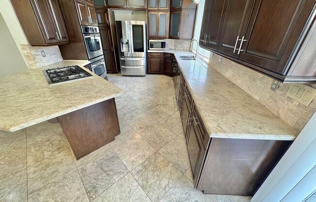 BEAUTIFUL TWO-STORY 4 BEDROOM 3 BATH HOME ON A CORNER LOT IN THE GUARD-GATED CANYON GATE COMMUNITY.