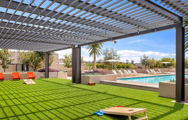 A patio with a pool and a table.