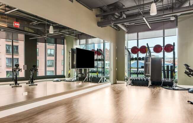 a workout room with a large window and gym equipment  at Cassidy on Canal, Chicago