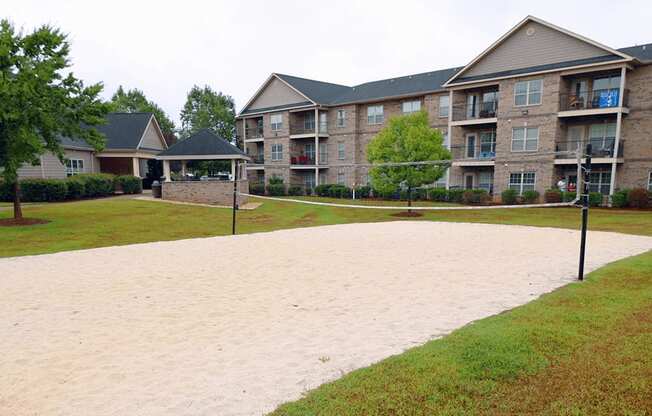 A sandy area in front of apartment buildings.