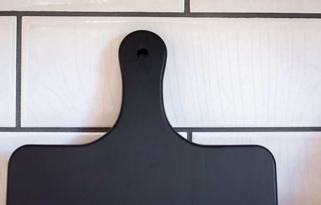 a black serving board with white tiles in the background