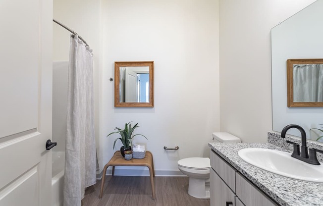 a bathroom with a toilet sink and shower