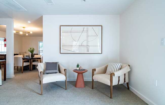 a living room with two chairs and a table