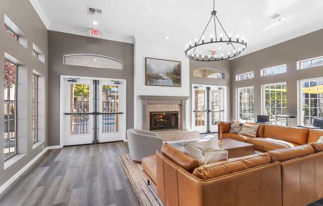 a living room with leather couches and a fireplace