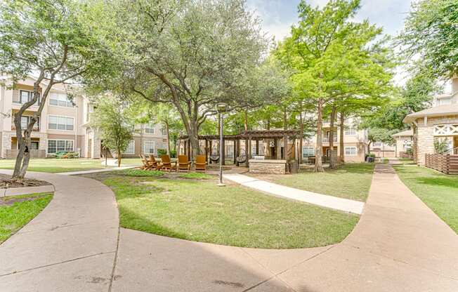A park with a walkway and trees.