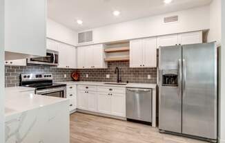 Fully-equipped kitchen with side by side refrigerator