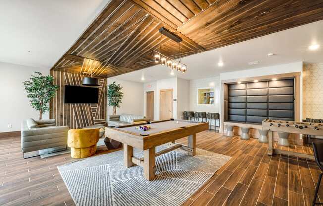 a game room with a pool table and a television